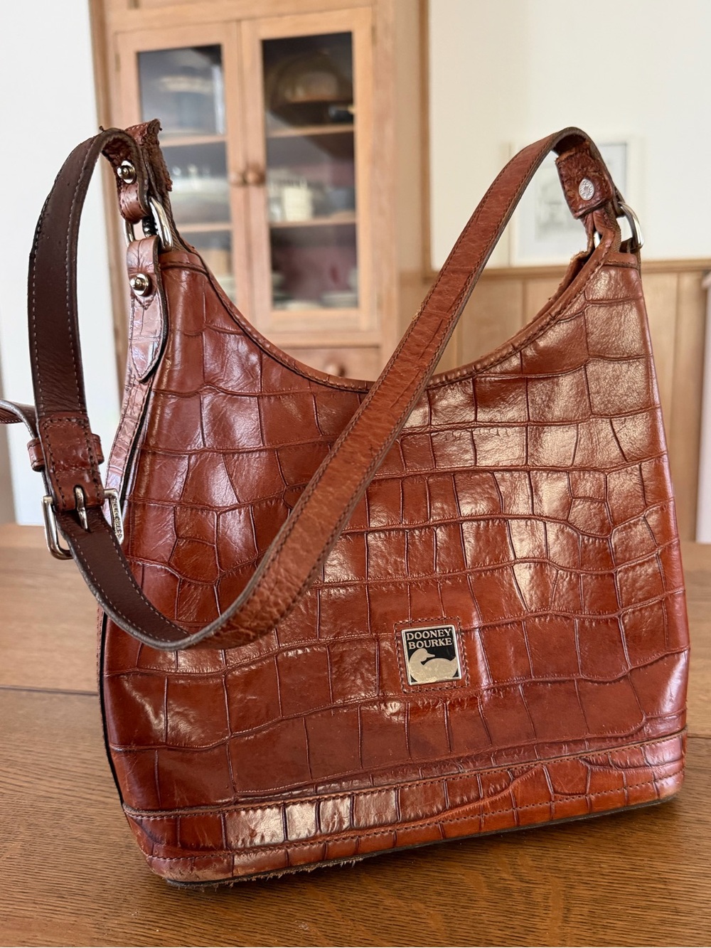Vintage 90s Dooney & Bourke brown crocodile-embossed leather hobo bag.